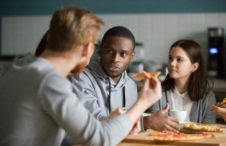 Young adults eating pizza