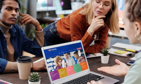 Students having a chat by laptop.