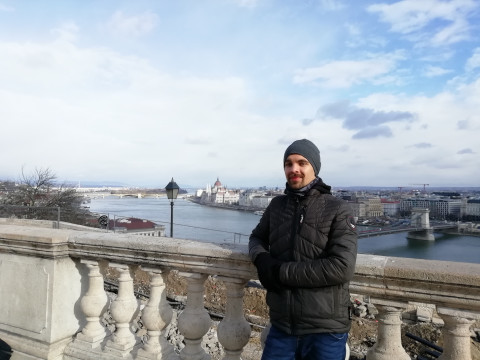 Student standing outside, on a bridge